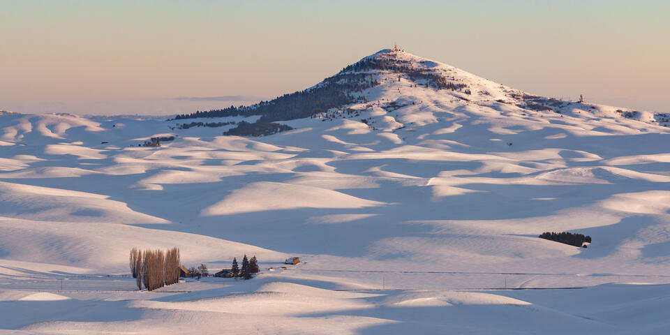 Steptoe Butte covered in snow at sunset.
